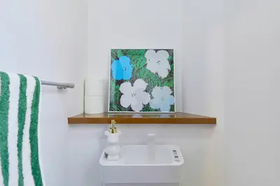 a bathroom with a sink and a picture on the wall at Yotsuya Lantern - Private 3 stories house for family in Tokyo