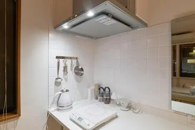 a kitchen with a sink with a coffee maker on it at Yotsuya Lantern - Private 3 stories house for family in Tokyo