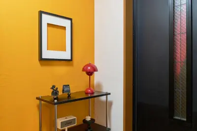a room with a table with a lamp and a mirror at Yotsuya Lantern - Private 3 stories house for family in Tokyo