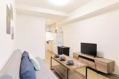 a living room with a couch and a tv at Yumegenzaka 201 - Vacation STAY 77670v in Tokyo