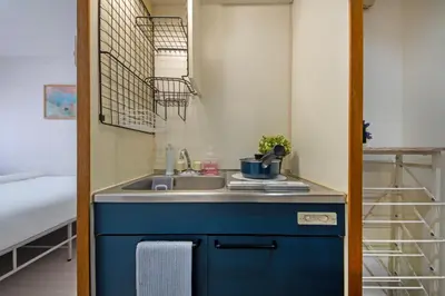a small kitchen with a sink in a room at CraftFlat Numabukuro 306, uphill residence in Tokyo