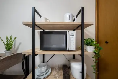 a microwave oven sitting on top of a shelf at CraftFlat Numabukuro 306, uphill residence in Tokyo