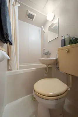 a white bathroom with a toilet and a sink at CraftFlat Numabukuro 306, uphill residence in Tokyo