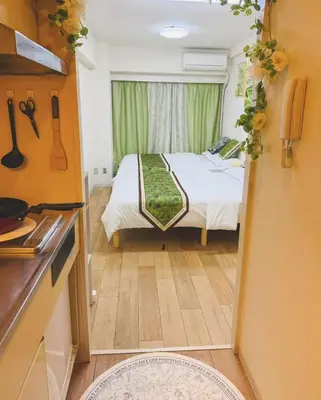 a small bedroom with a bed and a window at Shinjuku Downtown\u65b0\u5bbf in Tokyo
