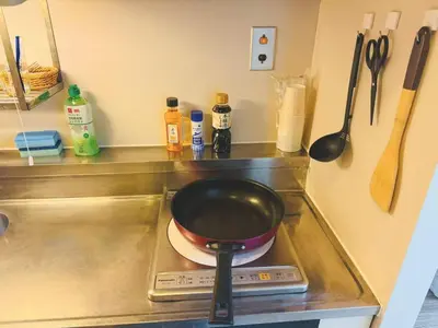 a frying pan sitting on top of a stove at Shinjuku Downtown\u65b0\u5bbf in Tokyo