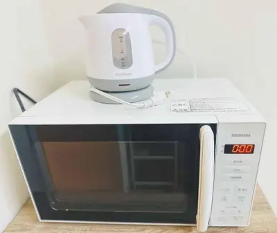 a white appliance sitting on top of a microwave at Shinjuku Downtown\u65b0\u5bbf in Tokyo