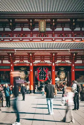 a group of people walking in front of a building at Shinjuku Downtown\u65b0\u5bbf in Tokyo
