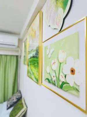 two pictures of flowers are hanging on a wall at Shinjuku Downtown\u65b0\u5bbf in Tokyo