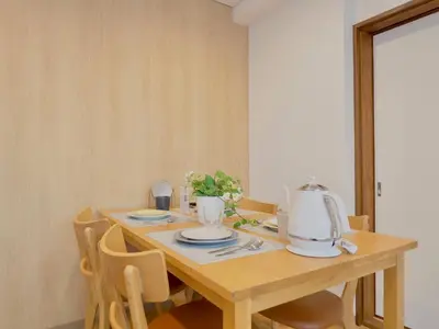 a dining room table with a tea kettle and chairs at Chitose Corp in Tokyo