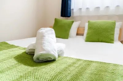 a room with two beds with towels on them at 202 Room, a 6-minute walk from Tokyo Koiwa Station Direct connected to Shinjuku and Akihabara Stations Comfortable one-bedroom apartment with separate wet and dry areas in Tokyo