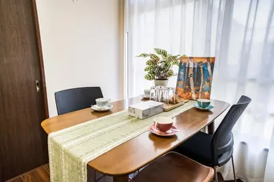 a dining room table with two chairs and a tablecloth on it at 202 Room, a 6-minute walk from Tokyo Koiwa Station Direct connected to Shinjuku and Akihabara Stations Comfortable one-bedroom apartment with separate wet and dry areas in Tokyo