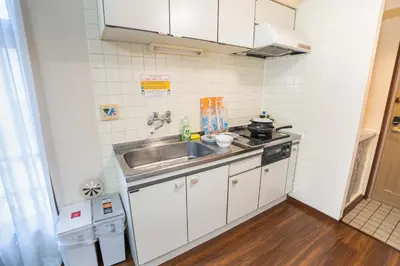 a small kitchen with a sink and a stove at 202 Room, a 6-minute walk from Tokyo Koiwa Station Direct connected to Shinjuku and Akihabara Stations Comfortable one-bedroom apartment with separate wet and dry areas in Tokyo