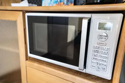 a microwave oven with its door open on a counter at 202 Room, a 6-minute walk from Tokyo Koiwa Station Direct connected to Shinjuku and Akihabara Stations Comfortable one-bedroom apartment with separate wet and dry areas in Tokyo