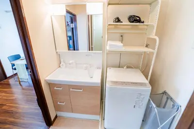 a bathroom with a sink and a washer and dryer at 202 Room, a 6-minute walk from Tokyo Koiwa Station Direct connected to Shinjuku and Akihabara Stations Comfortable one-bedroom apartment with separate wet and dry areas in Tokyo