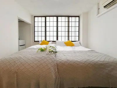 a bedroom with a large bed with flowers on it at Asakusa Sakura-F2 in Tokyo