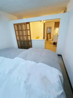 a bedroom with a large white bed in a room at Asakusa Sakura-F2 in Tokyo