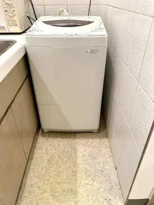 a washer and dryer in a kitchen with a sink at Asakusa Sakura-F2 in Tokyo