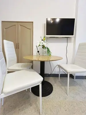 a room with a table and two chairs and a tv at Asakusa Sakura-F2 in Tokyo
