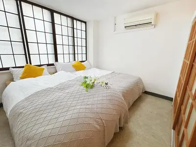 a bedroom with a large bed with flowers on it at Asakusa Sakura-F2 in Tokyo