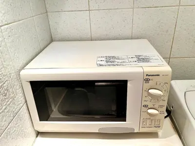a white microwave sitting on top of a counter at Asakusa Sakura-F2 in Tokyo
