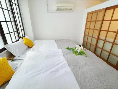 a bedroom with a bed with flowers on it at Asakusa Sakura-F2 in Tokyo