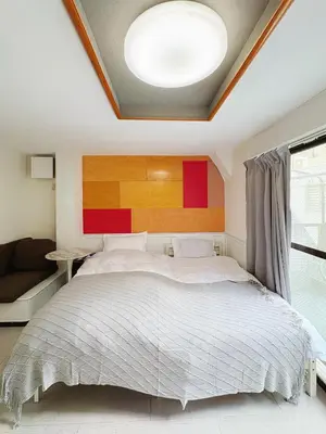 a bedroom with a large bed and a couch at Asakusa Sakura-3F in Tokyo
