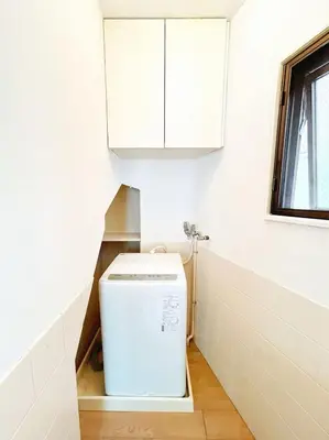 a washing machine in a kitchen with a white cabinet at Asakusa Sakura-3F in Tokyo