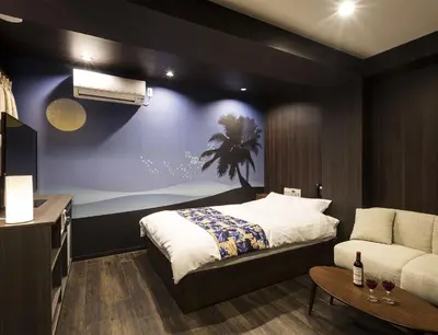a hotel room with a bed and a couch at Hotel La'i ローレル Adult only in Tokyo