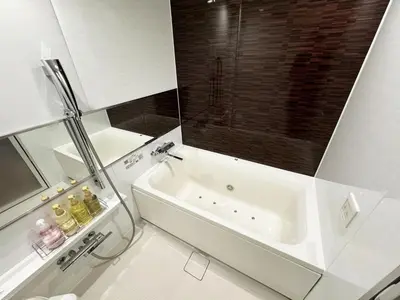 a white bathroom with a tub and a sink at Hotel La'i ローレル Adult only in Tokyo