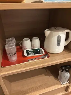 a shelf with a coffee maker and other items on it at Hotel La'i ローレル Adult only in Tokyo