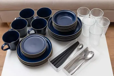 a group of blue plates and silverware on a table at \u30a2\u30f3\u30c9\u30b9\u30c6\u30a4\u6c38\u798f3\u4e01\u76ee202 in Tokyo