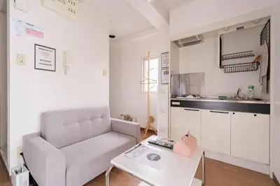 a living room with a couch and a table at \u30a2\u30f3\u30c9\u30b9\u30c6\u30a4\u6c38\u798f3\u4e01\u76ee301 in Tokyo