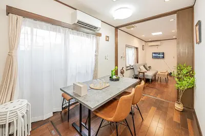 a dining room and living room with a table and chairs at \u685c\u306e\u5ddd70-42 \u99d2\u8fbc\u99c57\u5206 2-7\u4eba\u4e287 minutes from Komagome Station 2-7 people in Tokyo