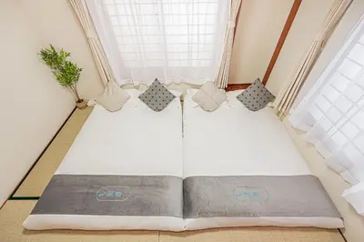 a bed in a small room with a window at \u685c\u306e\u5ddd70-42 \u99d2\u8fbc\u99c57\u5206 2-7\u4eba\u4e287 minutes from Komagome Station 2-7 people in Tokyo