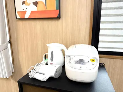 a white sewing machine sitting on top of a table at R&J Guest House, 2LDK, 5 min to JR Hirai, Direct to Akihabara and Shinjuku in Tokyo