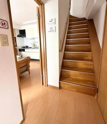 a hallway with a staircase in a house at R&J Guest House, 2LDK, 5 min to JR Hirai, Direct to Akihabara and Shinjuku in Tokyo