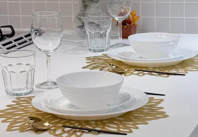 a table with plates and bowls and glasses on a counter at trias815 \u5e73\u548c\u5cf6102\u53f7\u5ba4 in Tokyo
