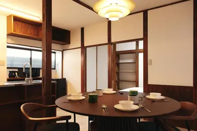 a dining room with a wooden table and chairs at North Shinjuku House in Tokyo