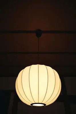 a light fixture hanging from a ceiling at North Shinjuku House in Tokyo