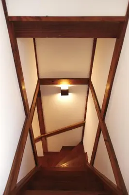 an overhead view of a wooden ceiling with a light at North Shinjuku House in Tokyo