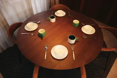 a wooden table with plates and utensils on it at North Shinjuku House in Tokyo