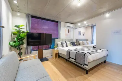 a bedroom with a bed and a flat screen tv at trias815 \u5e73\u548c\u5cf6202\u53f7\u5ba4 in Tokyo