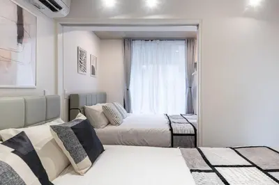 a bedroom with two beds and a window at trias815 \u5e73\u548c\u5cf6202\u53f7\u5ba4 in Tokyo
