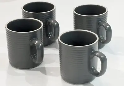 four black coffee cups sitting on a white table at trias815 \u5e73\u548c\u5cf6202\u53f7\u5ba4 in Tokyo