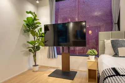 a living room with a flat screen tv on a wall at trias815 \u5e73\u548c\u5cf6202\u53f7\u5ba4 in Tokyo