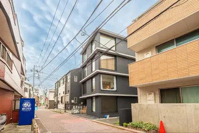 an empty street in a city with buildings at trias815 \u5e73\u548c\u5cf6202\u53f7\u5ba4 in Tokyo