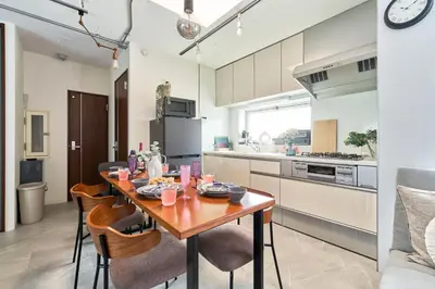 a kitchen with a wooden table and chairs in a room at Fuufu House Tokyo Yotsuya - No Elevator 3F WalkUp in Tokyo