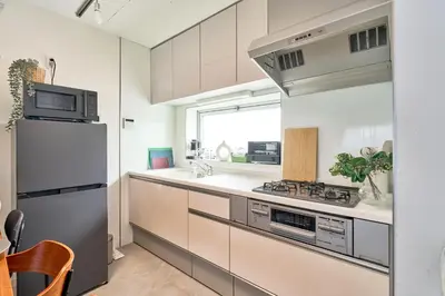a kitchen with a refrigerator and a stove top oven at Fuufu House Tokyo Yotsuya - No Elevator 3F WalkUp in Tokyo