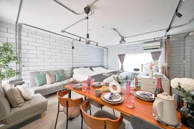 a living room with a table and a couch at Fuufu House Tokyo Yotsuya - No Elevator 3F WalkUp in Tokyo