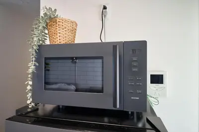 a microwave oven sitting on top of a stove at Fuufu House Tokyo Yotsuya - No Elevator 3F WalkUp in Tokyo